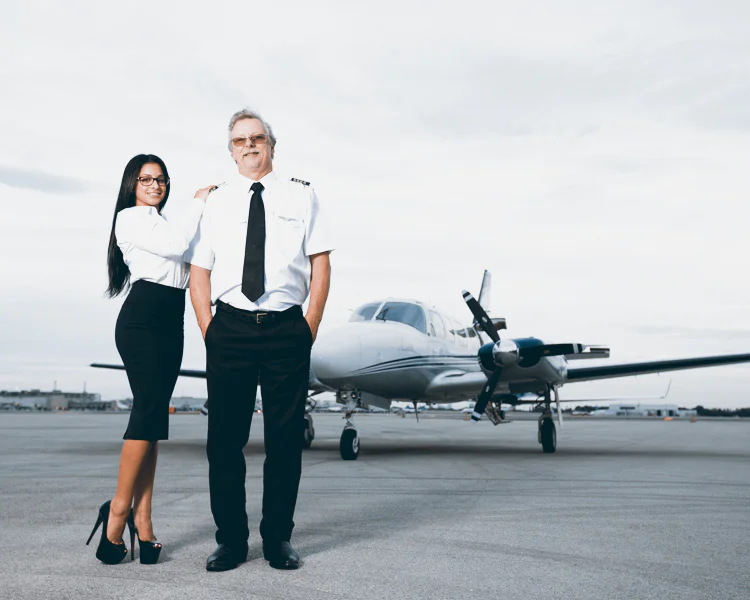 a pilot and a flight attendant in front of a turboprop