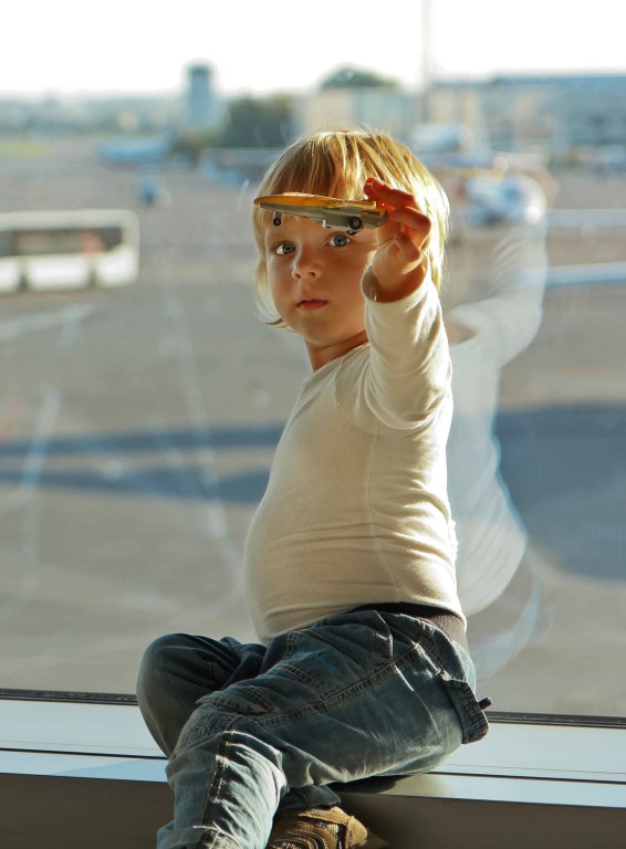 a child holding a small toy plane